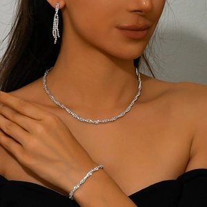 Elegant silver rhinestone jewelry set with necklace bracelet and earrings on a model
