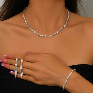 Elegant silver rhinestone jewelry set with twisted necklace, bracelet and tassel earrings