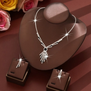 Elegant silver and black rhinestone necklace and earring set on a velvet display stand