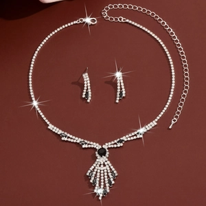 Detailed macro view of sparkling rhinestone bridal necklace set with black tassel pendant