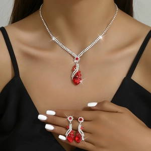 Elegant bridal necklace and earrings set featuring red heart-shaped crystals and zircons