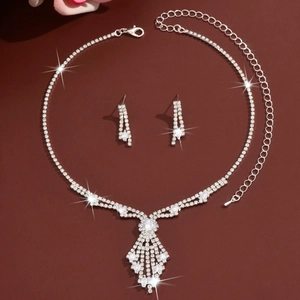 Close-up of sparkling rhinestone necklace and earrings bridal jewelry set on dark background