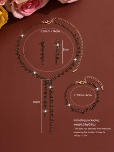 Detailed view of gold necklace set with black rhinestones and size specifications