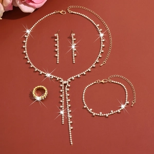 Detail of elegant gold rhinestone jewelry set with long fringe necklace and bracelet