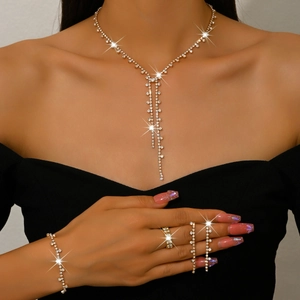 Sparkling gold bridal jewelry set with diamond chain necklace earrings and ring on model