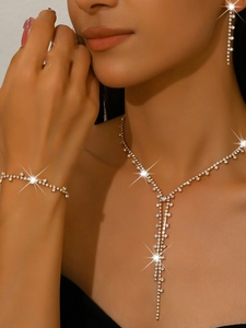 Close-up of elegant gold chain necklace with sparkling crystals on female model
