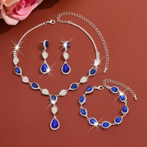 Detailed view of silver wedding jewelry set featuring blue pear-cut crystals and starbursts
