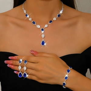 Detailed view of luxury bridal jewelry set with blue pear-cut crystals and silver plating