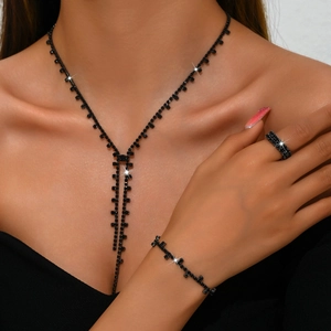 Elegant black rhinestone jewelry set with necklace and ring featuring a unique link design