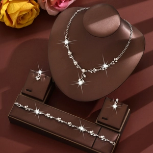 Detailed view of silver bridal jewelry set with pearls and leaf-shaped rhinestones