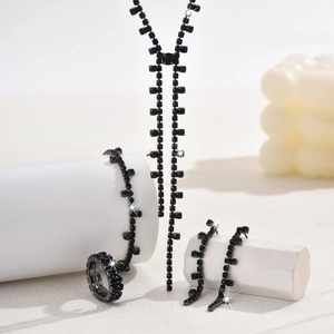 Detailed view of elegant black rhinestone jewelry set with necklace, bracelet, and ring
