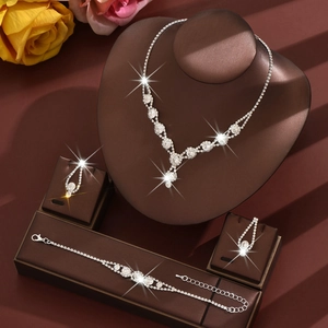 Elegant silver bridal jewelry set with sparkling rhinestones, including necklace and earrings