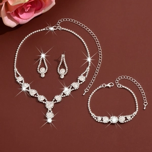 Elegant bridal jewelry set with silver rhinestones including necklace, earrings and bracelet