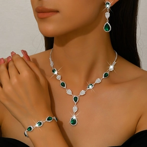 Elegant 3-piece silver jewelry set with teardrop emerald crystals and sparkling diamonds
