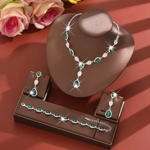 Detailed set of silver bridal jewelry with dark green teardrop crystals and pavé diamonds
