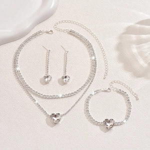 Close-up of sparkling heart rhinestone necklace, earrings, and bracelet bridal set