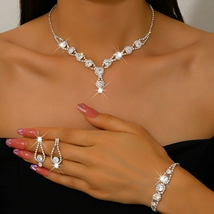 Elegant bridal rhinestone jewelry set with V-shaped necklace, teardrop earrings and bracelet