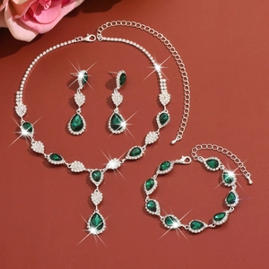 Detailed view of emerald crystal necklace set with pear-cut stones and silver settings