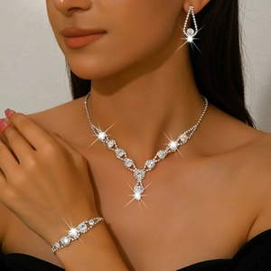 Elegant silver bridal jewelry set with V-shaped necklace, bracelet and drop earrings