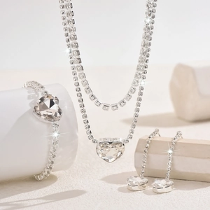 Detailed macro shot of heart-shaped crystal bridal jewelry set with sparkling rhinestones