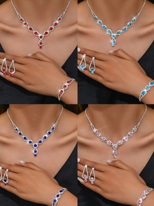 Detail view of sparkling rhinestone jewelry set in red, pink, and blue color variants