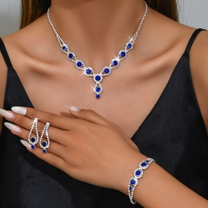Elegant silver jewelry set with blue rhinestones including necklace earrings and bracelet