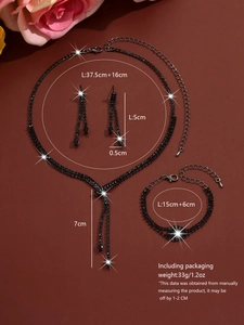 Flat lay of black tassel necklace set with earrings and bracelet on red background