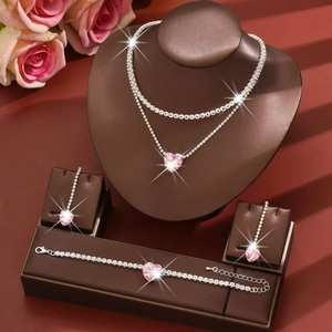 Detail of pink heart crystal jewelry set including necklace earrings and bracelet