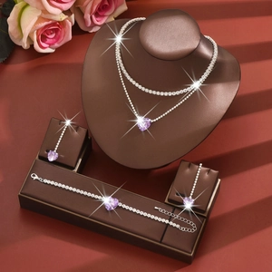 Detail of purple heart jewelry set including layered necklace and matching earrings