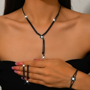 Three-piece black rhinestone jewelry set with tassel necklace, bracelet and earrings