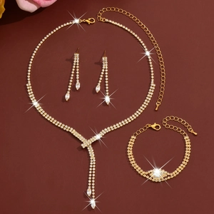 Macro detail of gold bridal jewelry set with sparkling tassels and clear zircons