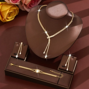 Three-piece gold fringe necklace set with sparkling rhinestones and matching earrings