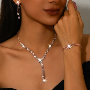 Three-piece rose gold jewelry set with rhinestone tassel necklace, bracelet and earrings