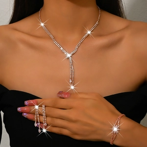 Detailed view of rhinestone fringe necklace and bracelet set in rose gold plating