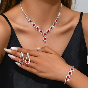 Detailed view of women's sparkling red rhinestone necklace, bracelet and earrings set