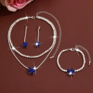 Detail view of heart-shaped blue rhinestone jewelry set with necklace and earrings