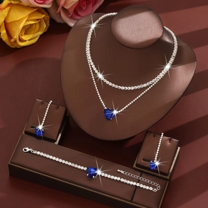 Detail view of silver heart jewelry set with blue crystals and sparkling rhinestones