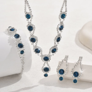 Elegant silver-tone bridal jewelry set with sparkling blue sapphire-style stones and diamonds
