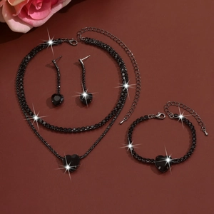 Detail shot of black heart-shaped gemstone jewelry set including necklace and earrings
