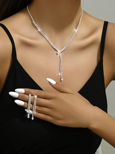 Detail shot of model wearing silver bridal tassel necklace and long fringe earrings set