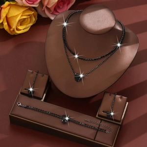 Detail of a black spinel jewelry set featuring a double necklace and heart pendants