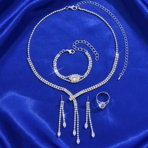 Luxurious silver jewelry set with sparkling zircons including necklace, bracelet, and earrings