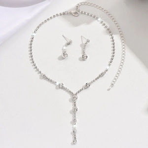 Macro detail of silver necklace and earring set with shimmering zircon crystals