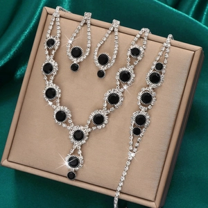 Detail of silver bridal jewelry set with black gemstones and white rhinestones