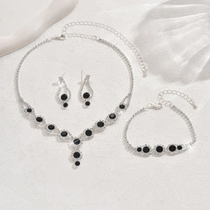 Detailed shot of silver bridal jewelry set featuring black gems and sparkling rhinestones