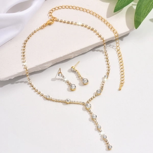 Elegant gold jewelry set featuring zircon studded Y-shaped necklace and matching earrings