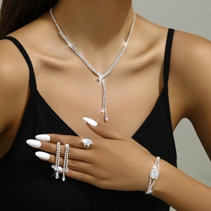 Silver fringe necklace and earring set with crystals on model in black outfit