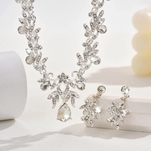 Detailed macro view of sparkling rhinestone bridal necklace and leaf earrings set