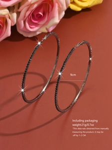 Detail of 9cm gunmetal hoop earrings with black rhinestones and size specifications