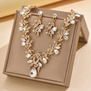 Golden bridal jewelry set with floral vine necklace and pear-cut crystal earrings